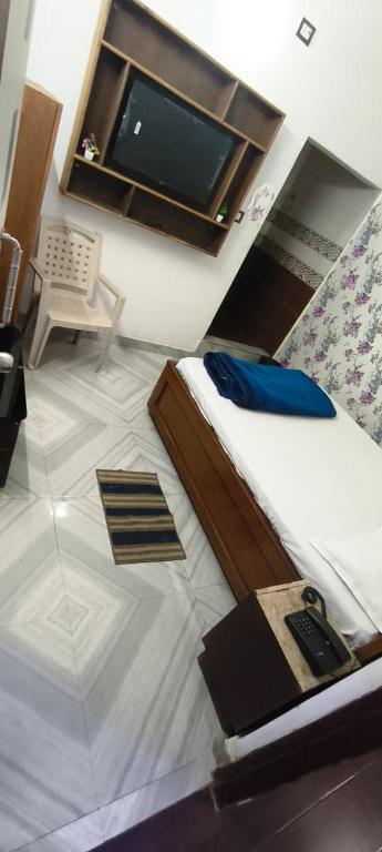a bedroom with a bed and a tv in it at Hotal Relax in Saharsa