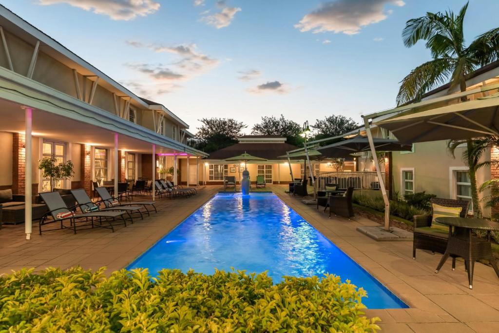 a swimming pool in the middle of a house at Protea Hotel by Marriott Nelspruit in Nelspruit