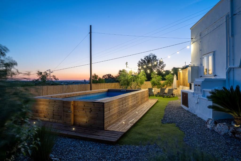 a swimming pool in the backyard of a house at Trullo Petronella in Cisternino