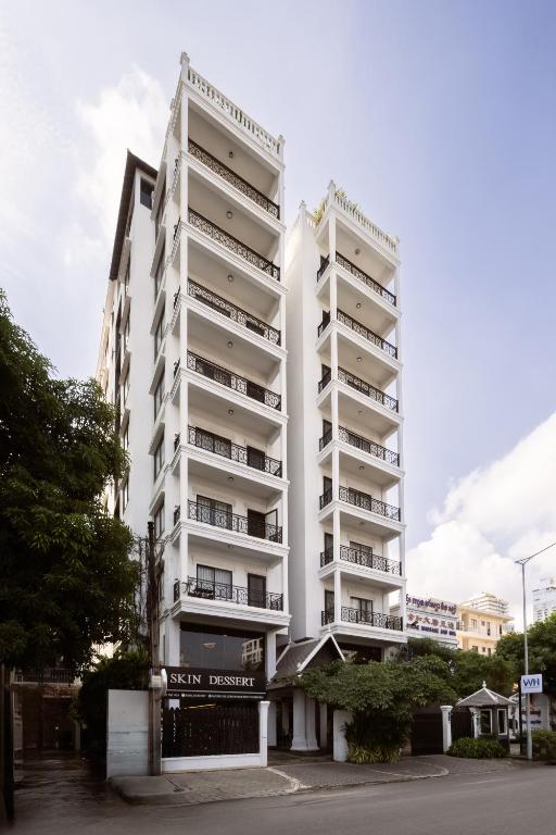 two tall white apartment buildings in a city at WH302 Residence by WH in Phnom Penh