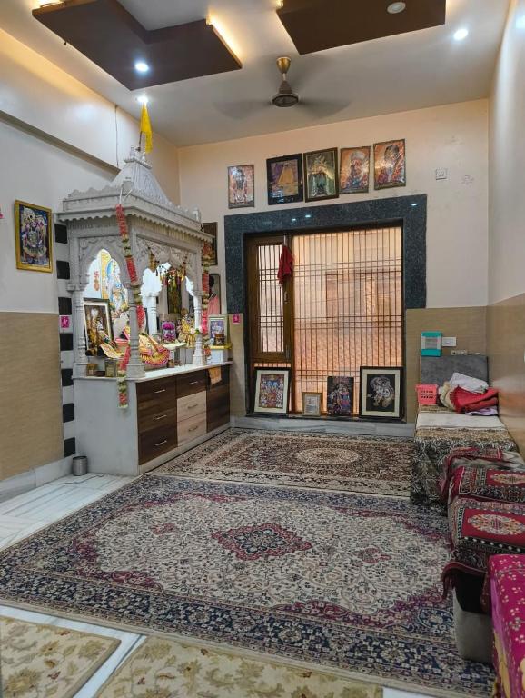 a room with a large rug on the floor at Gopal Dham in Govardhan