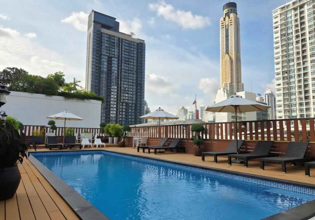 a swimming pool on top of a building with buildings at True Siam Rangnam Hotel in Bangkok