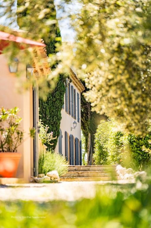 a building with blue doors and ivy on it at le Mas des Pignes -adults only in Aix-en-Provence