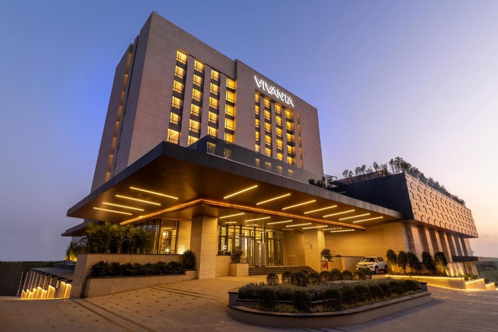a hotel building with lights in front of it at Vivanta Vrindavan in Vrindāvan
