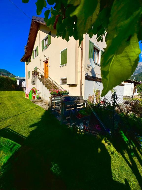 a house with a bench in front of it at Casa Furlan in Calalzo