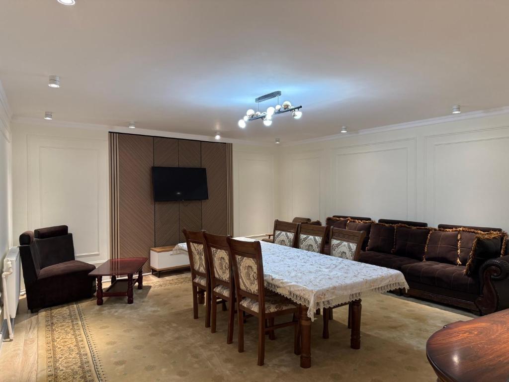 a living room with a table and a couch at Apartment Registon in Samarkand