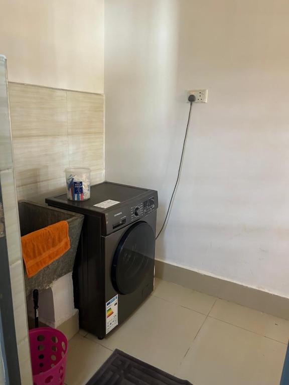 a washer and dryer in a small room at Cytonn unique suits in Ruaka