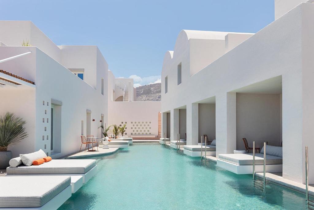 a pool in the middle of a building at Viva Nove Suites in Kamari