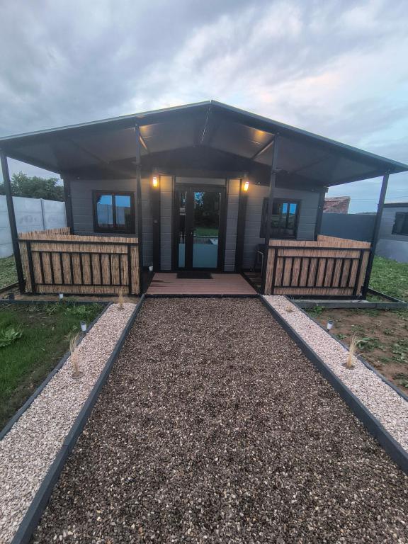 a small building with a porch and a door at Studio MAT in Herly