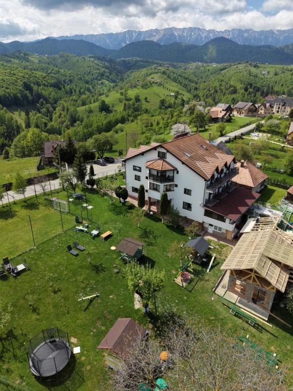 an aerial view of a house on a green field at Pensiunea Tabacaru in Peştera