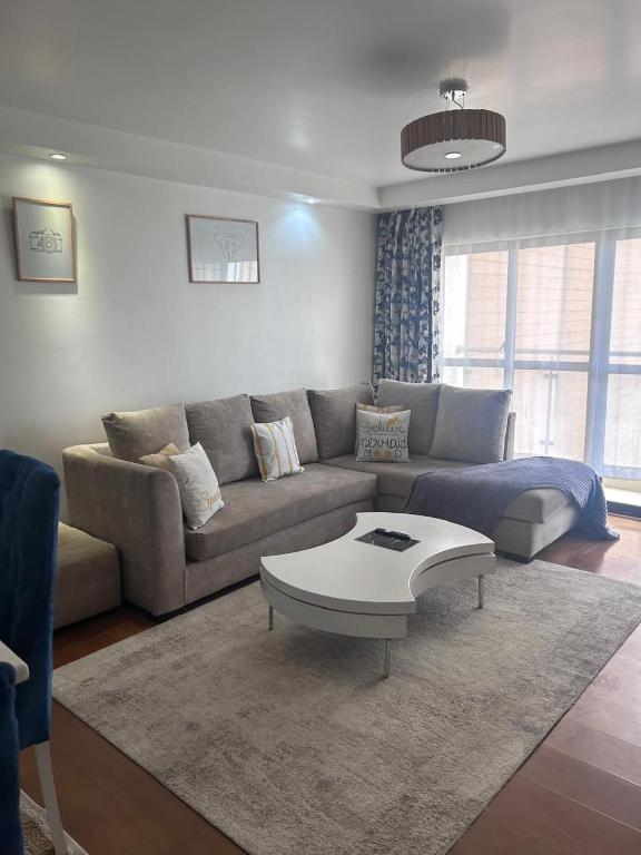 a living room with a couch and a coffee table at Best west residence in Ruaka