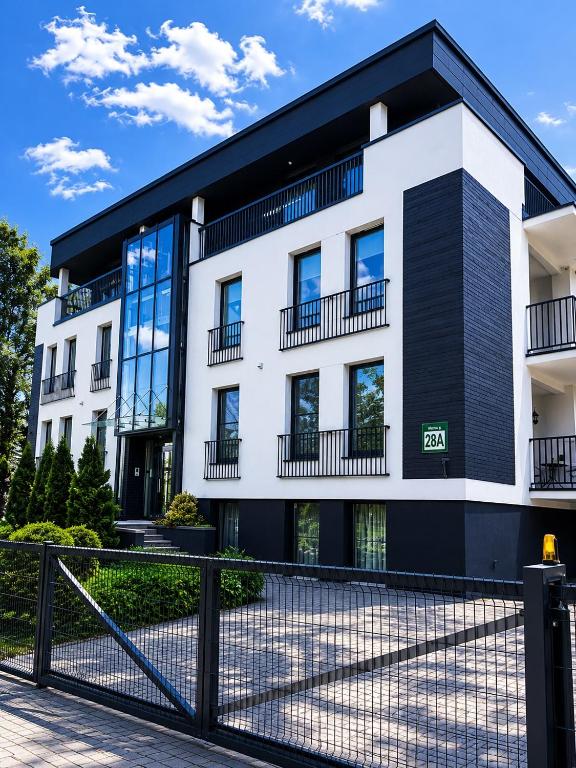 an apartment building with a black and white facade at Centre Apartment in Druskininkai