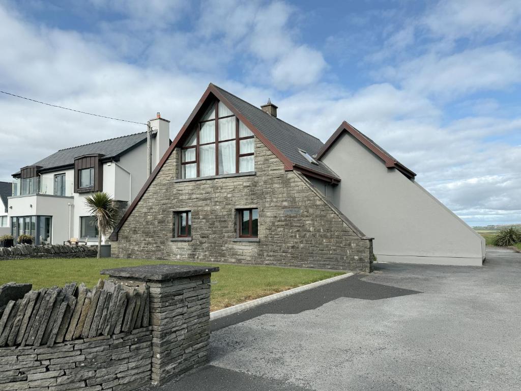 a large white house with a brick at Dough Lodge in Lahinch