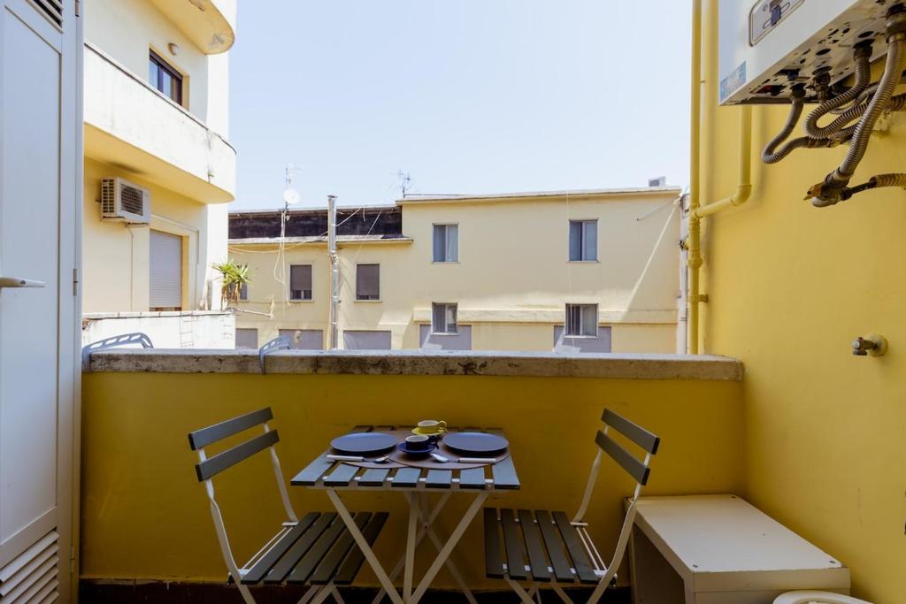 a table and chairs on the balcony of a building at Toledo Apartment until 7 people 2 bathrooms in Naples