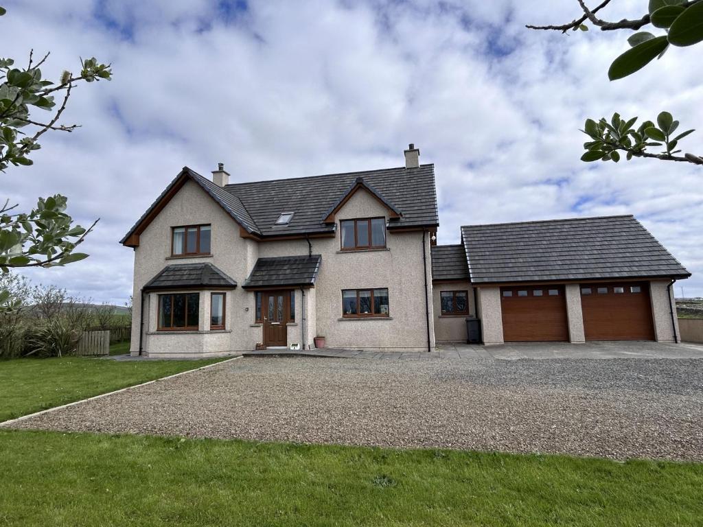 a large white house with a garage at Nistagar, Harray, Orkney - OR00604F in Harray