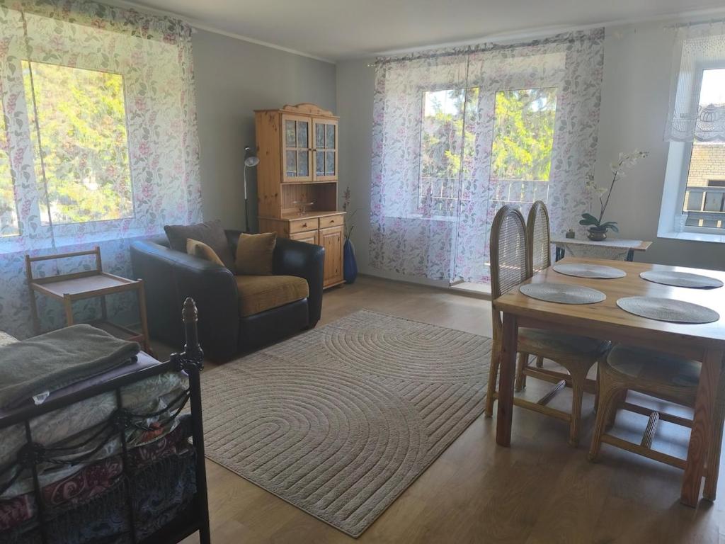 a living room with a couch and a table at Vormsi Ohvitseride maja korter nr 6 in Hullo