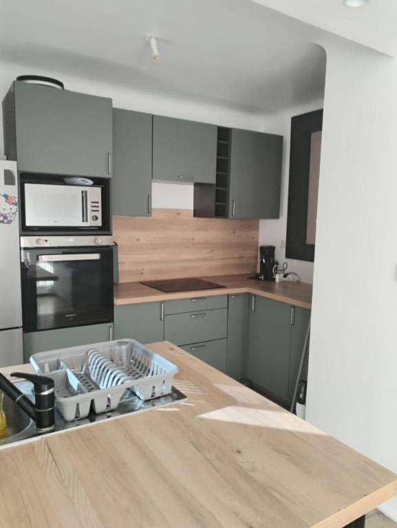 a kitchen with a wooden counter top with a stove top oven at JenAlya in Vallauris