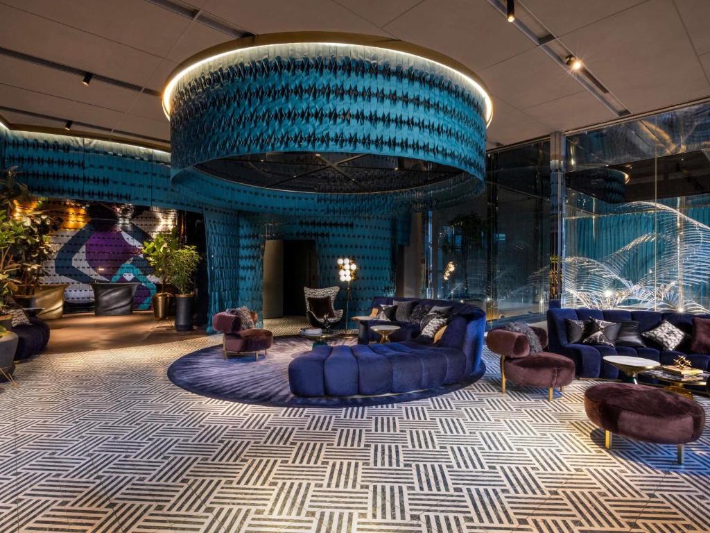 a lobby with blue furniture and a blue ceiling at Mercure Tokyo Hibiya in Tokyo