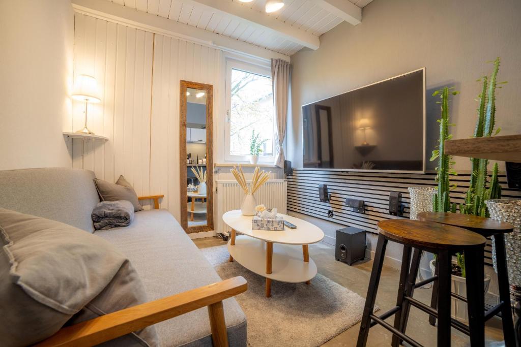 a living room with a couch and a table at Tiny Loft Harz in Sankt Andreasberg