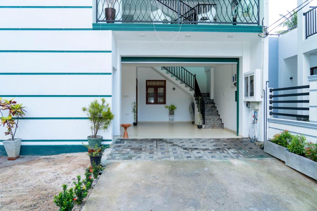 a hallway of a white building with a staircase at JY Apartments in Negombo