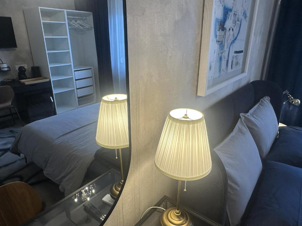 a bedroom with two lamps and a bed and a mirror at Ema's double bedroom in Umag