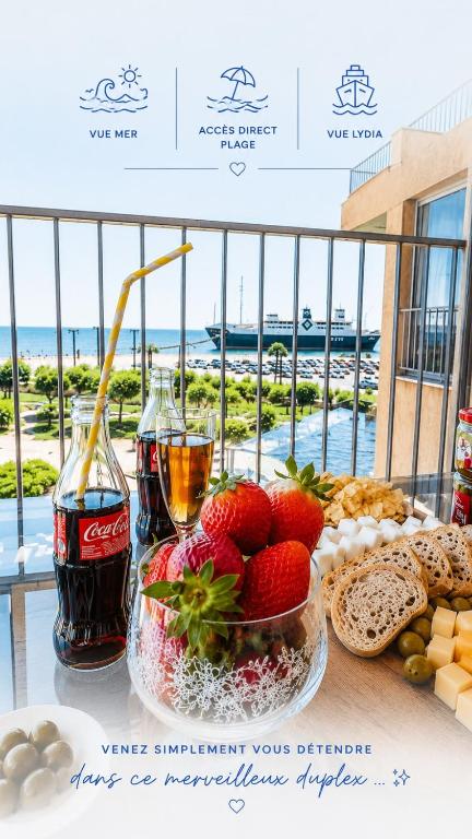 a table topped with food and two glasses of soda at Le Lydia - Duplex - Vue Mer - Accès direct Plage - Parking - Barbecue in Le Barcarès