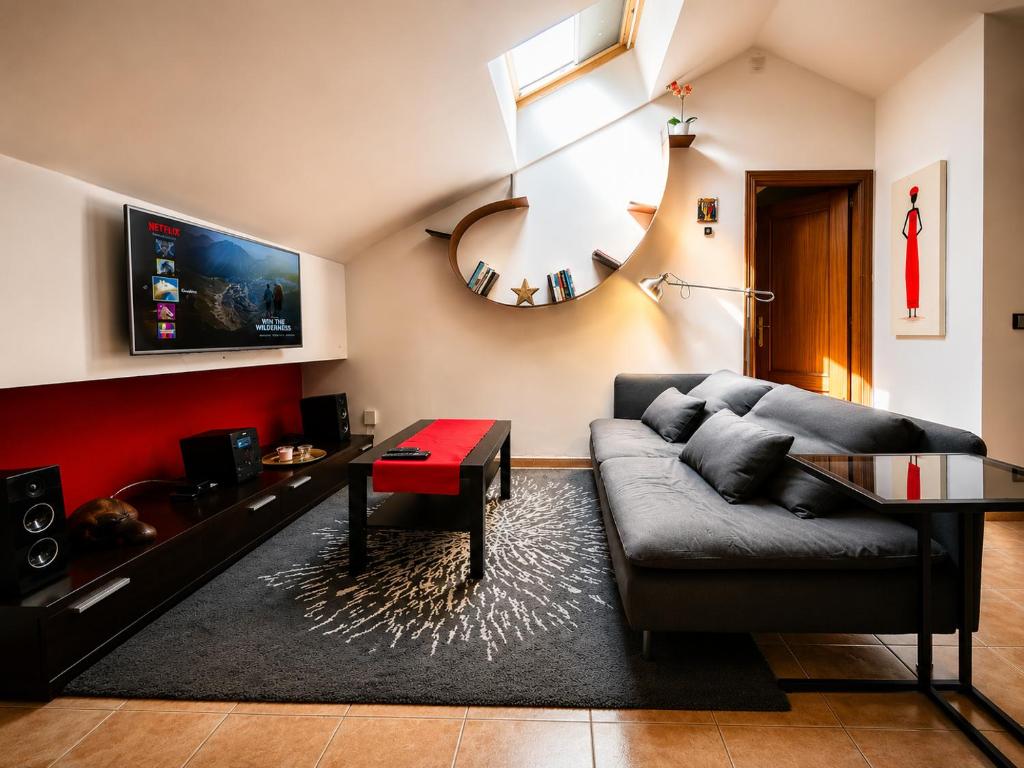 a living room with a couch and a table at Ático Centro Málaga in Málaga