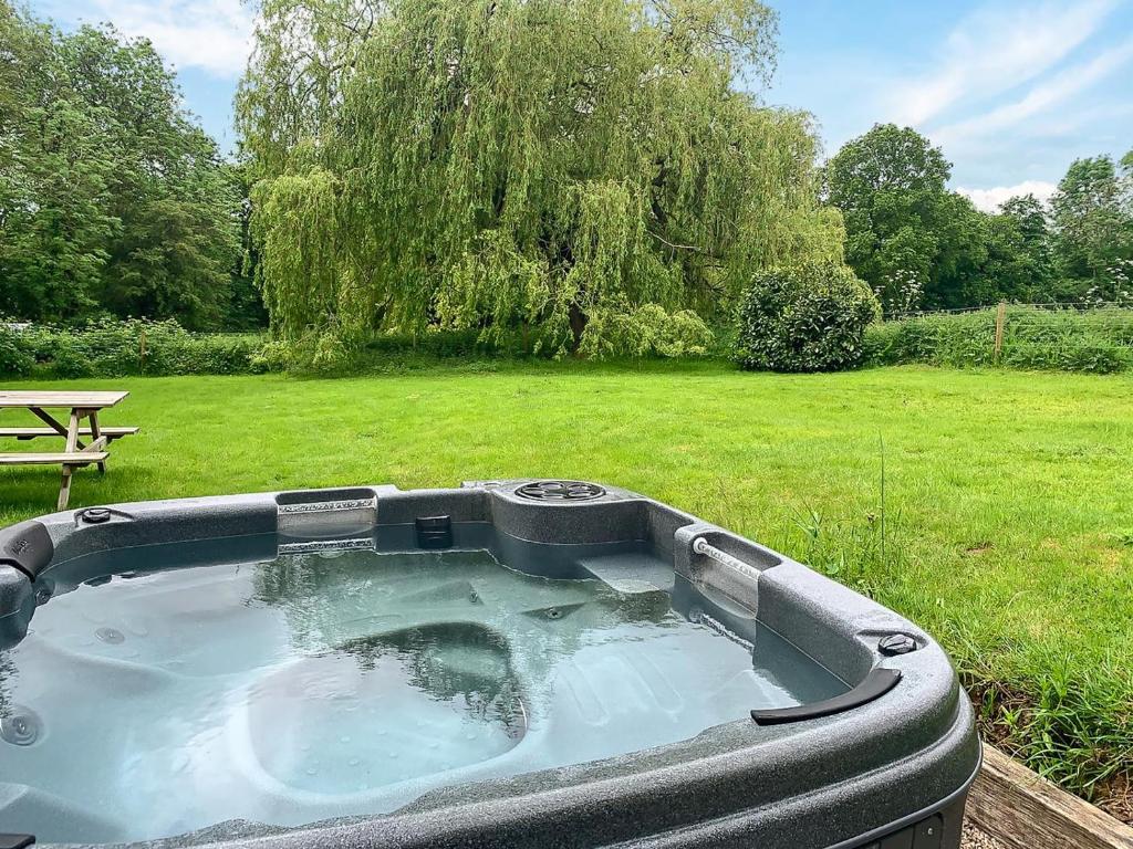 a jacuzzi tub in a yard with a field at 3 Bed in Southwell oc-s30603 in Southwell