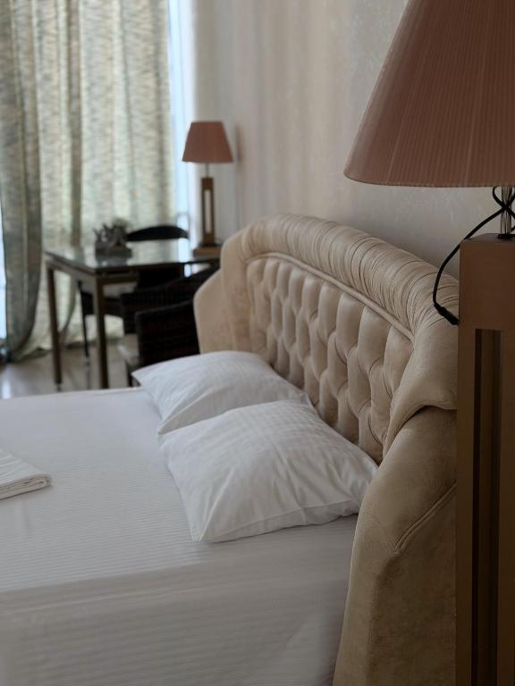 a bedroom with a bed with a pillow on it at Sea Cloud Hotel in Zatoka