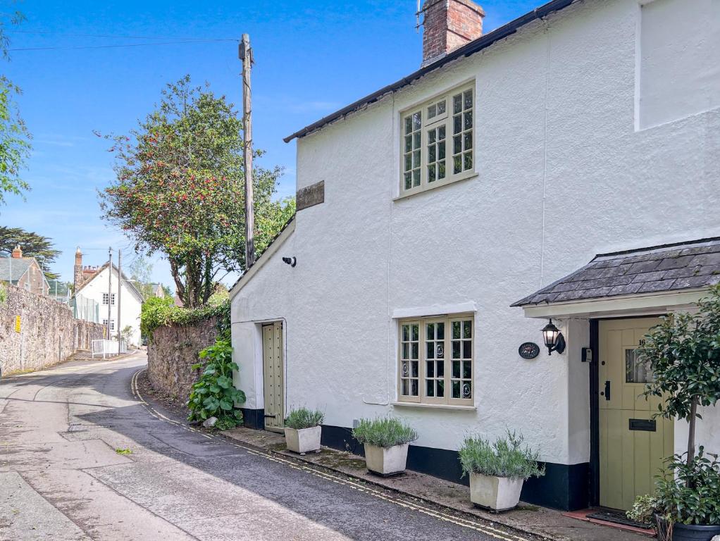 a white house on the side of a street at Ruffles Cottage Dunster in Dunster
