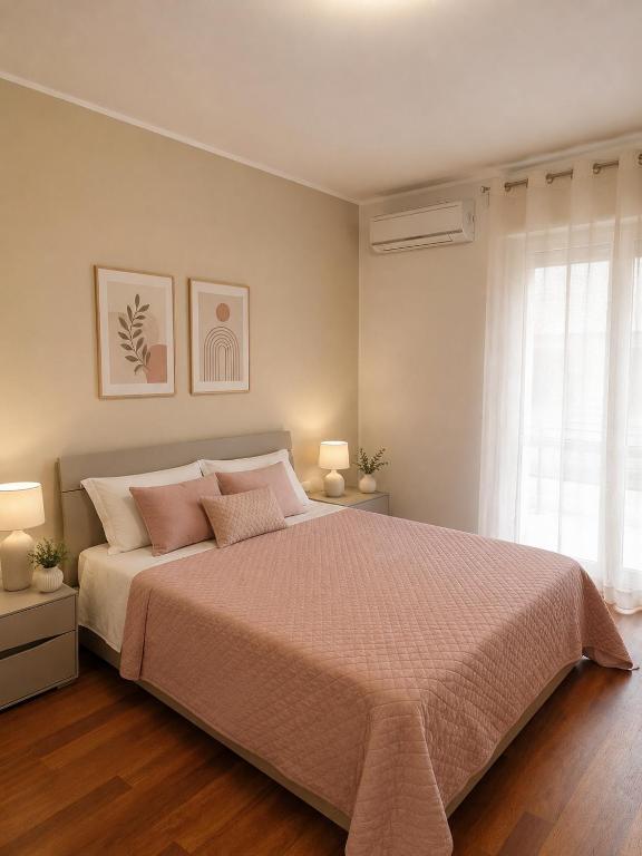 a bedroom with a bed with two lamps and a window at In Piazza Pompeii in Pompei