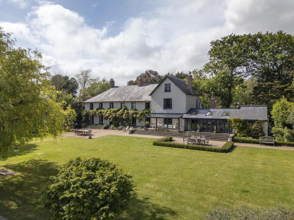 a large white house with a large yard at Hazelhurst in Sway