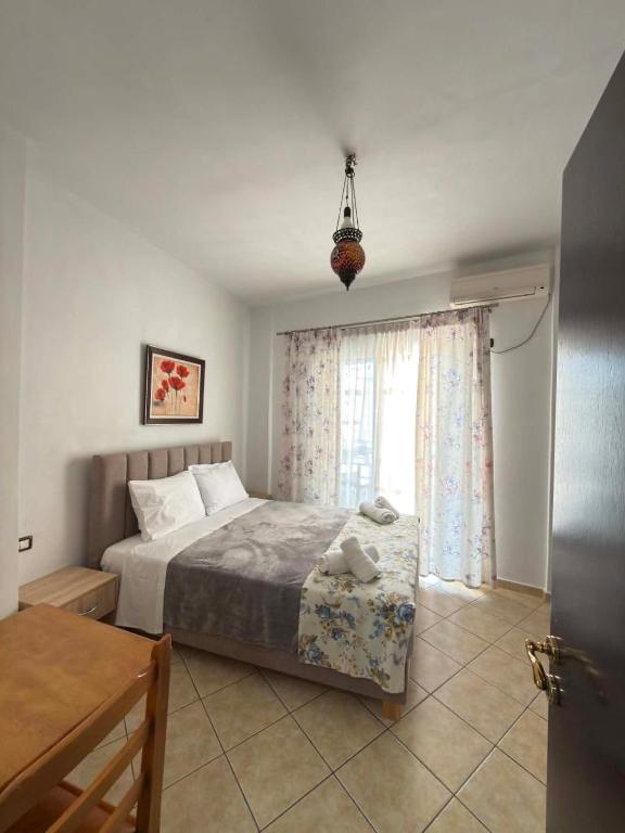 a bedroom with a bed and a window at The Rock Apartments in Himare