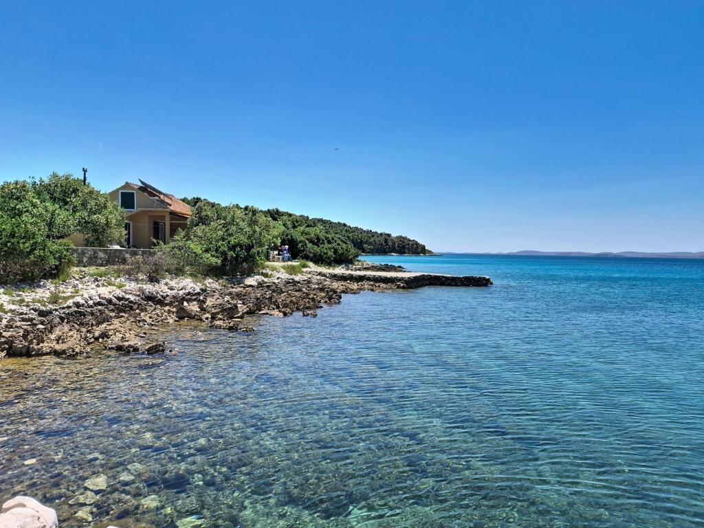 a house on the shore of a body of water at Holiday Home Rudi by Interhome in Kraj