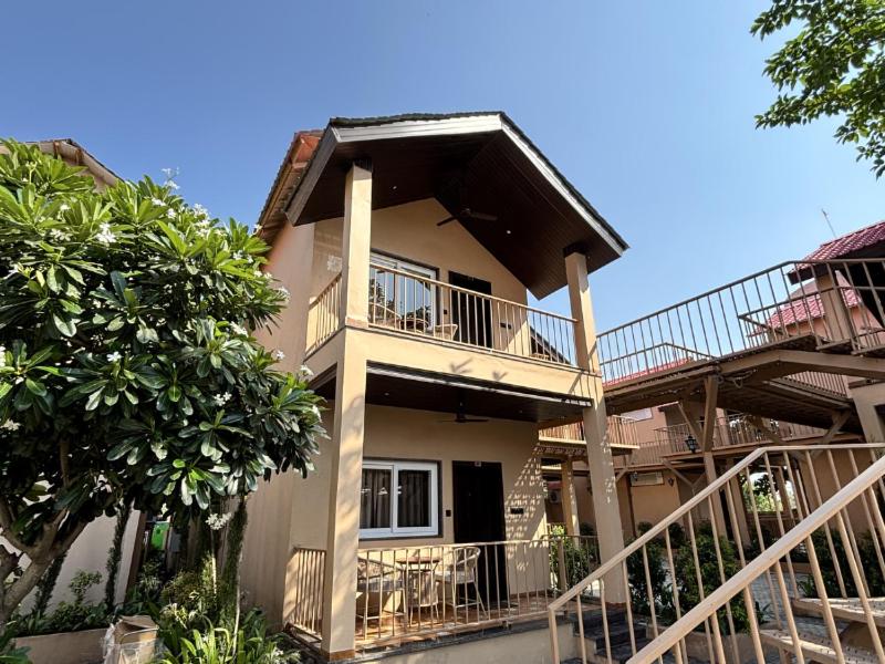 a house with a balcony and stairs in front of it at Velora The Luxury Resort in Māndu