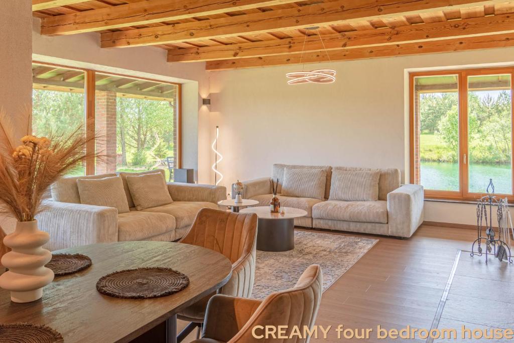 a living room with a couch and a table at Prie Trakų in Petkėniškės