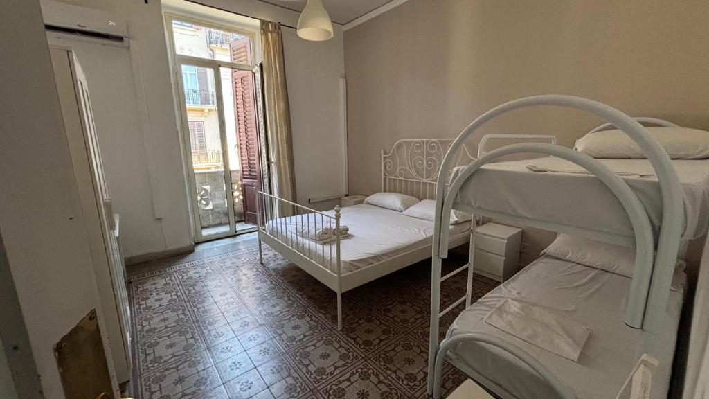 a room with two bunk beds and a window at Sunset hostel Palermo in Palermo
