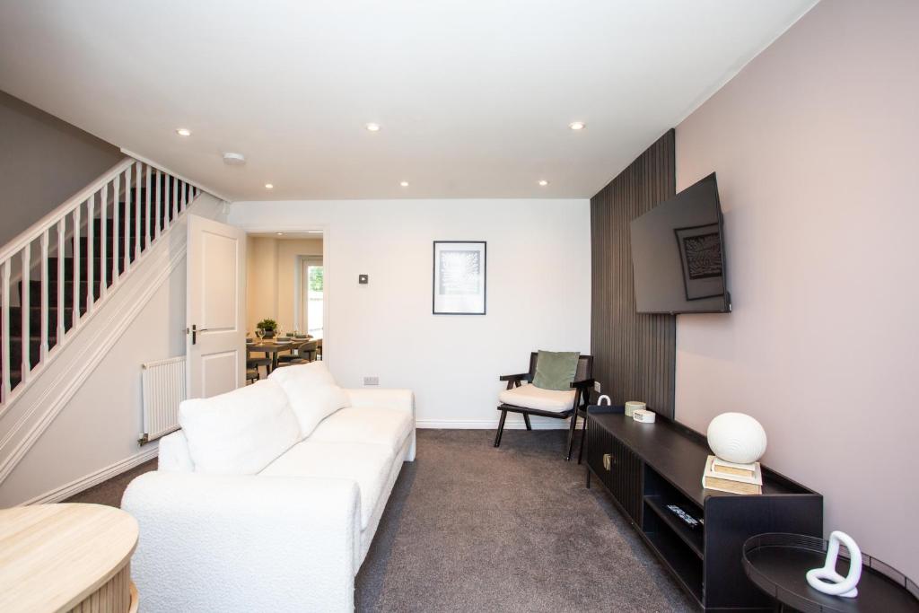 a living room with a white couch and a table at Arkless Grove FREE Parking WiFi in Black Hill