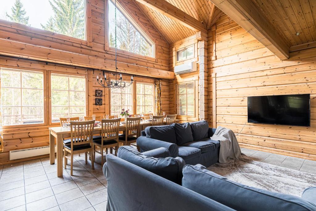 a living room with a couch and a table and a television at Koivulankaari 17 in Tahkovuori
