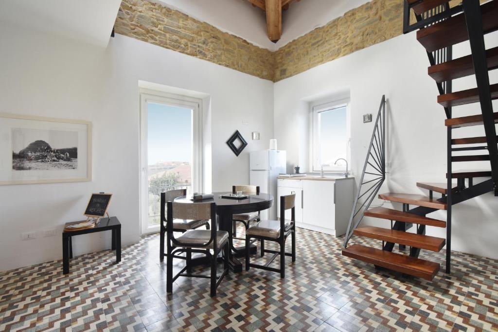 a living room with a table and chairs and stairs at Monti d'Abruzzo in Crecchio