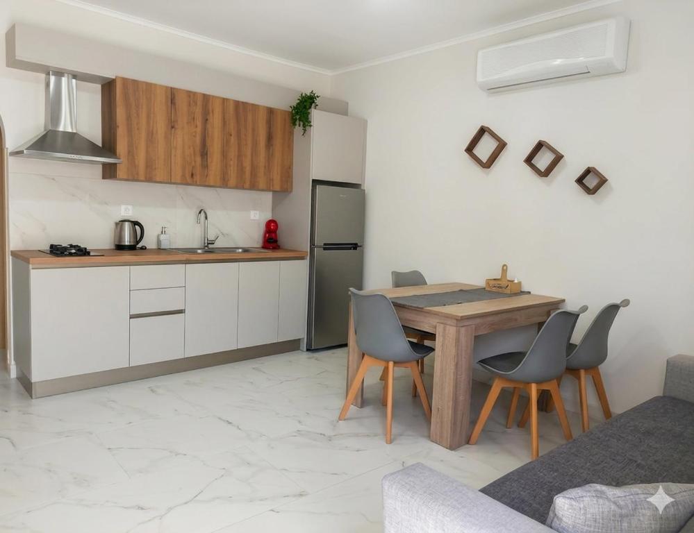 a kitchen with a wooden table and chairs in a room at Electra Gaios Apartment in Gaios