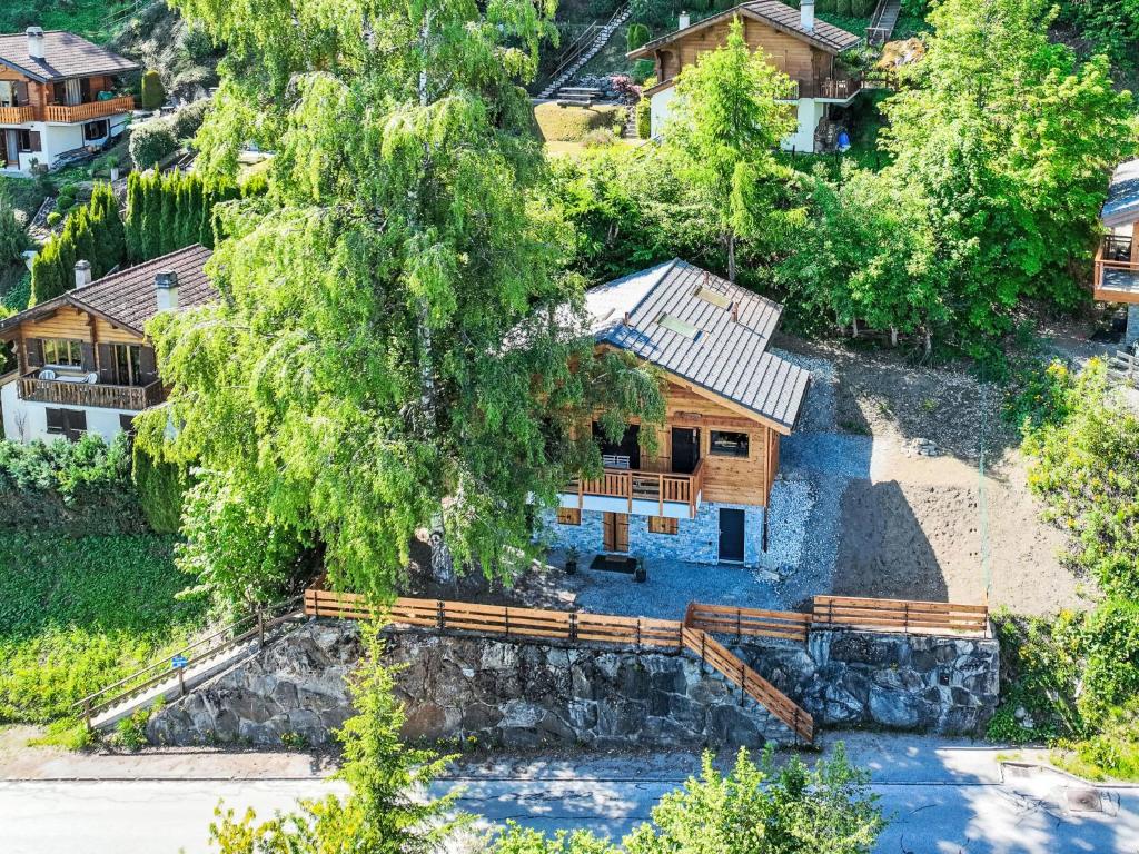 an aerial view of a log cabin with a tree at Chalet Byzance by Interhome in Nendaz