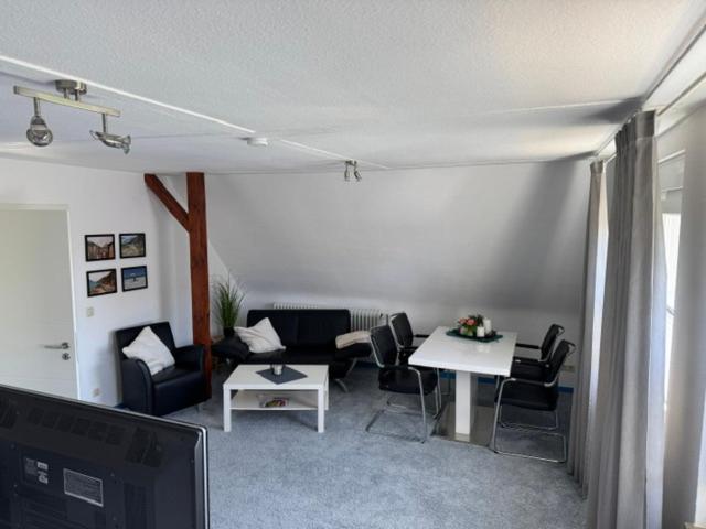 a living room with a couch and chairs and a tv at Apartment Düte in Erpen