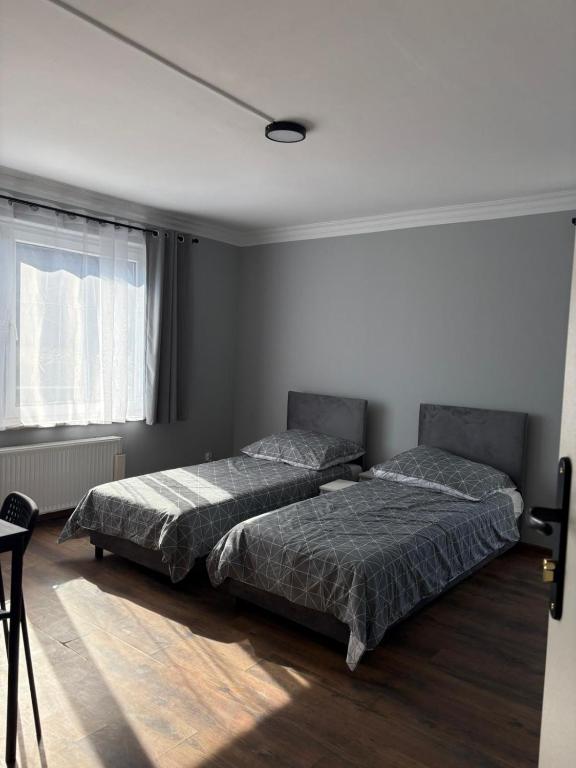 a bedroom with two beds and a window at Horiza in Gdańsk