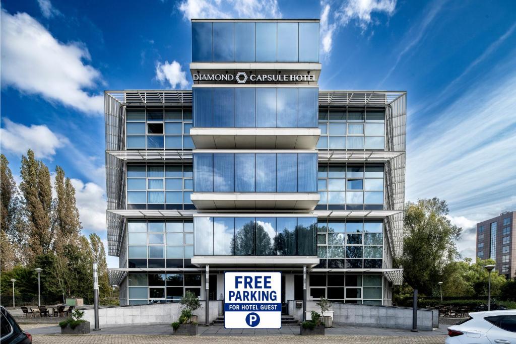 a free parking sign in front of a building at Diamond Capsule Hotel Amsterdam South in Amstelveen