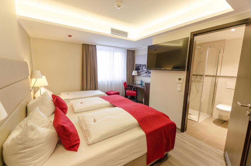 Postel nebo postele na pokoji v ubytování hotel bomonti Nürnberg West
