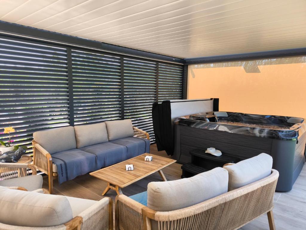 a living room with a couch and a table at Au Ch'ti Suisse in Autechaux