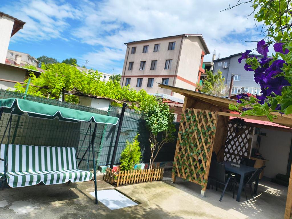 a patio with two chairs and a umbrella at Casa Tesmao in Constanţa