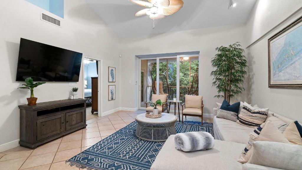 a living room with a couch and a flat screen tv at 907 Mariners Club in Key Largo