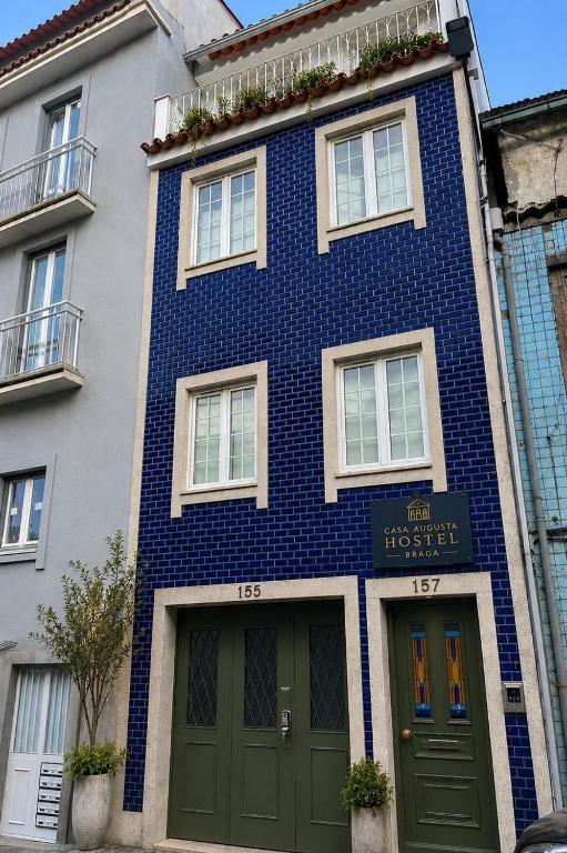a blue and white building with two doors at Casa Augusta 6 in Braga
